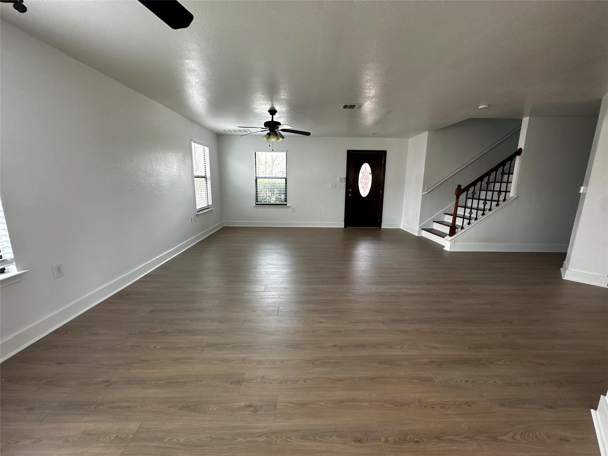 8016 Bannock Lane Austin, TX 78747 - Photo 5 of 32 an empty room with wooden floor and windows