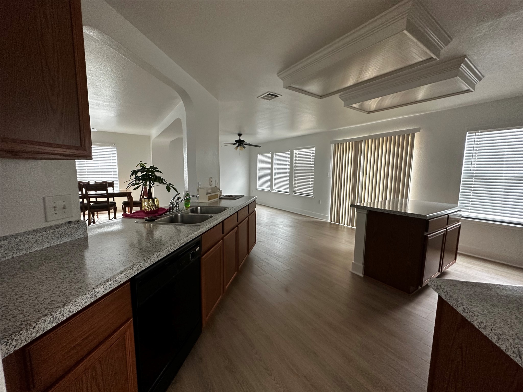 8016 Bannock Lane Austin, TX 78747 - Photo 30 of 32 a kitchen with stainless steel appliances granite countertop a sink a stove and a wooden floors