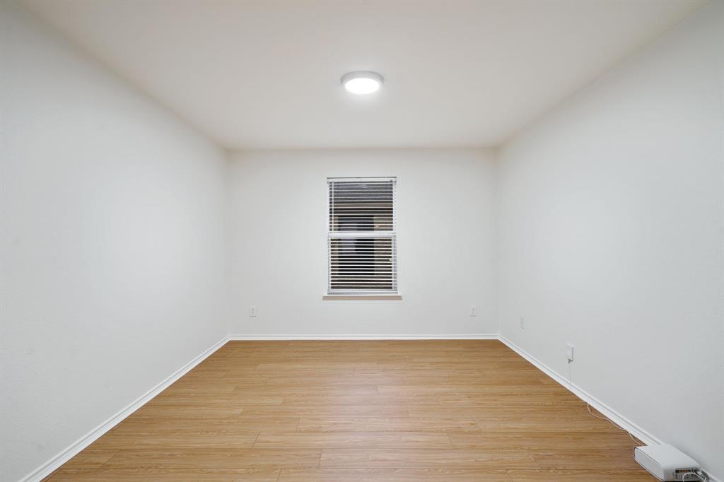 14813 North Spring Ridge Circle Balch Springs, TX 75180 - Photo 11 of 22 a view of empty room with wooden floor and fan