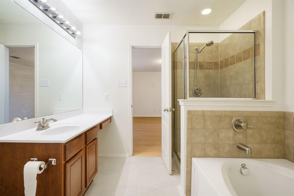 14813 North Spring Ridge Circle Balch Springs, TX 75180 - Photo 19 of 22 a bathroom with a sink and a mirror