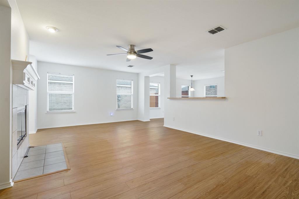 14813 North Spring Ridge Circle Balch Springs, TX 75180 - Photo 5 of 22 an empty room with wooden floor and windows