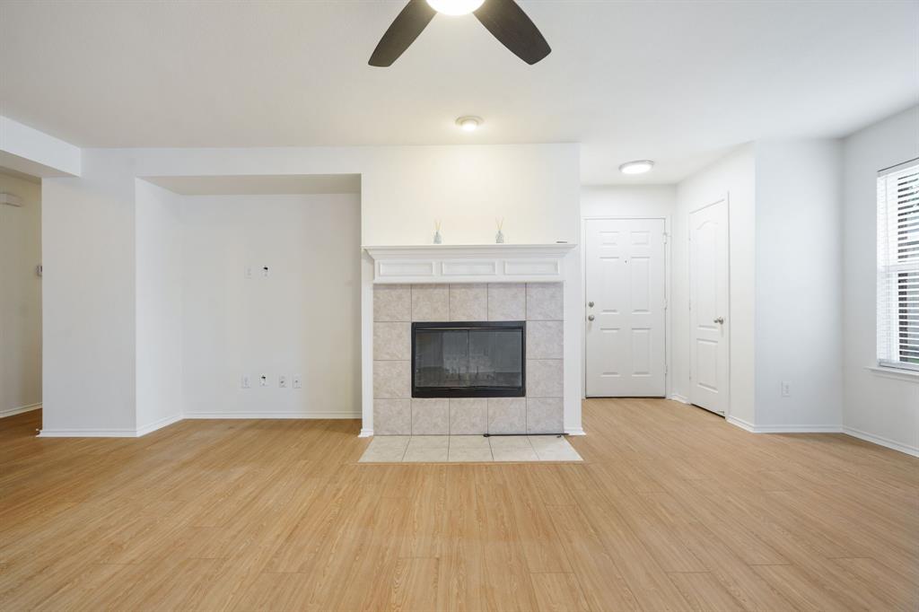 14813 North Spring Ridge Circle Balch Springs, TX 75180 - Photo 6 of 22 a view of an empty room with wooden floor and a fireplace
