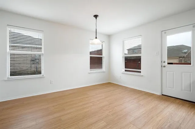 a view of a room window and wooden floor
