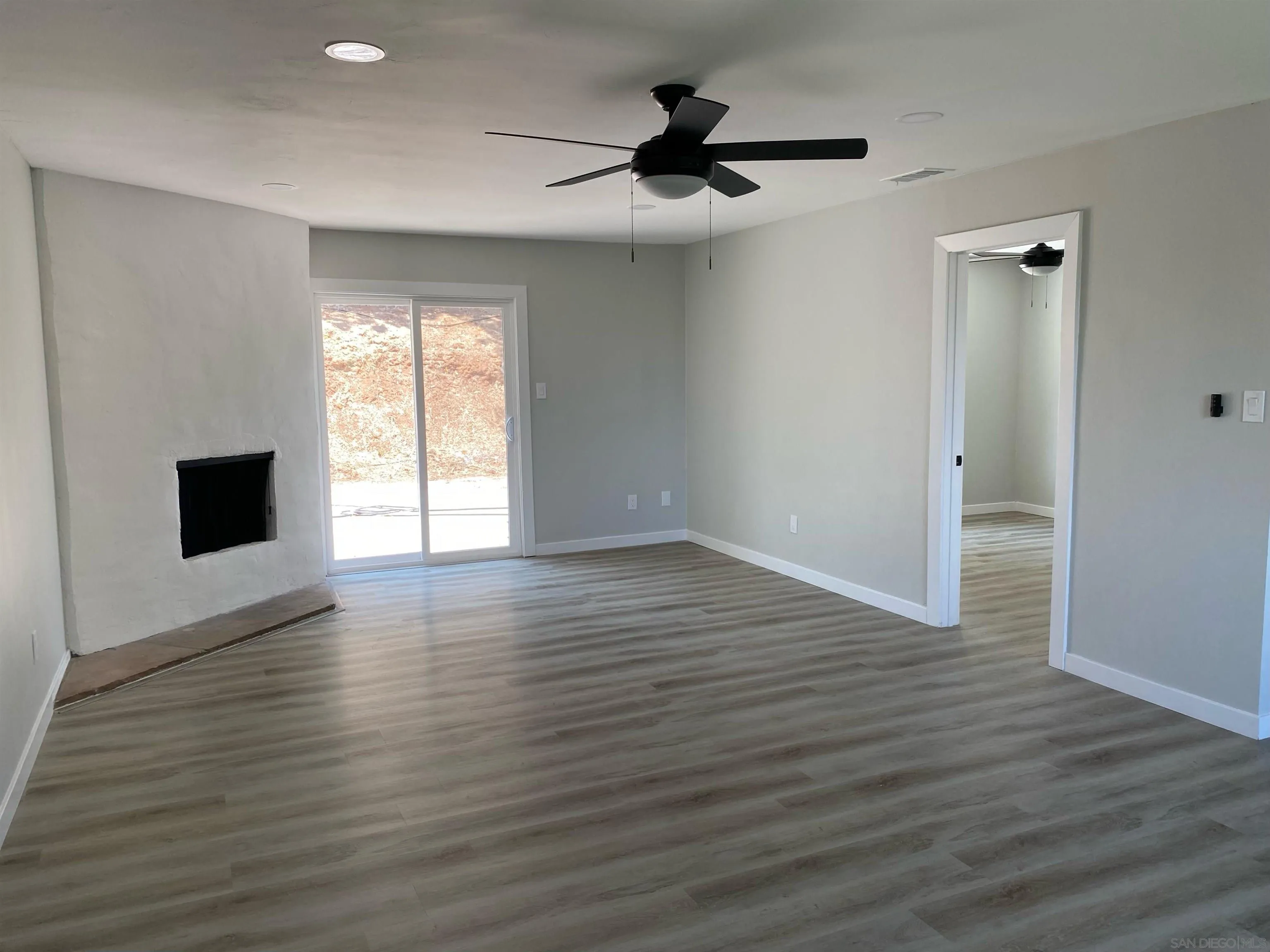 3866 Spring Drive Spring Valley, CA 91977 - Photo 1 of 9 a view of an empty room with wooden floor and a window