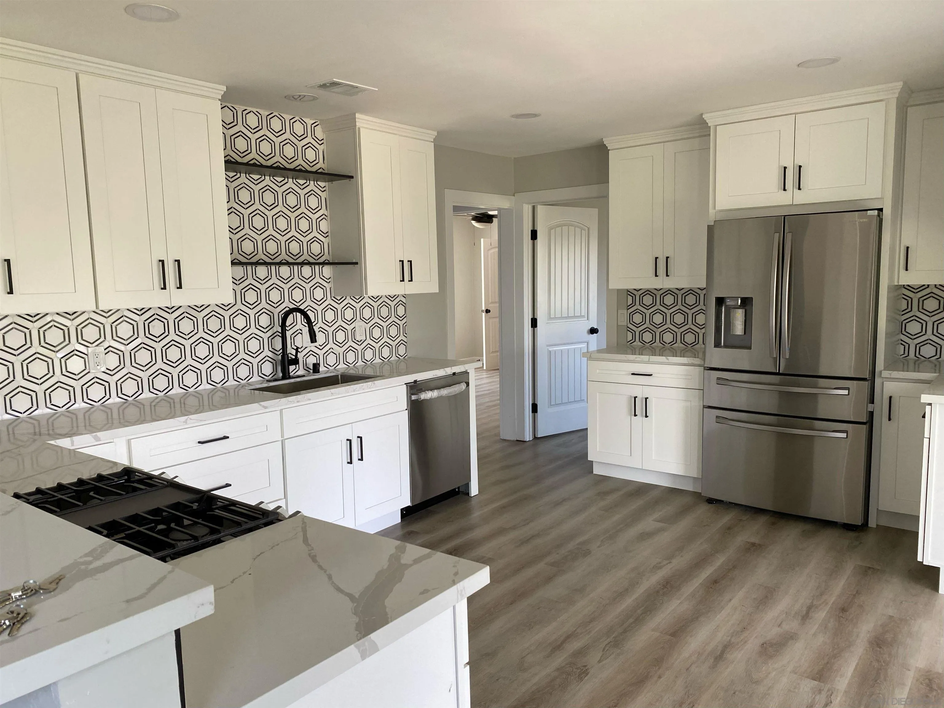 3866 Spring Drive Spring Valley, CA 91977 - Photo 3 of 9 a kitchen with stainless steel appliances a refrigerator sink and cabinets