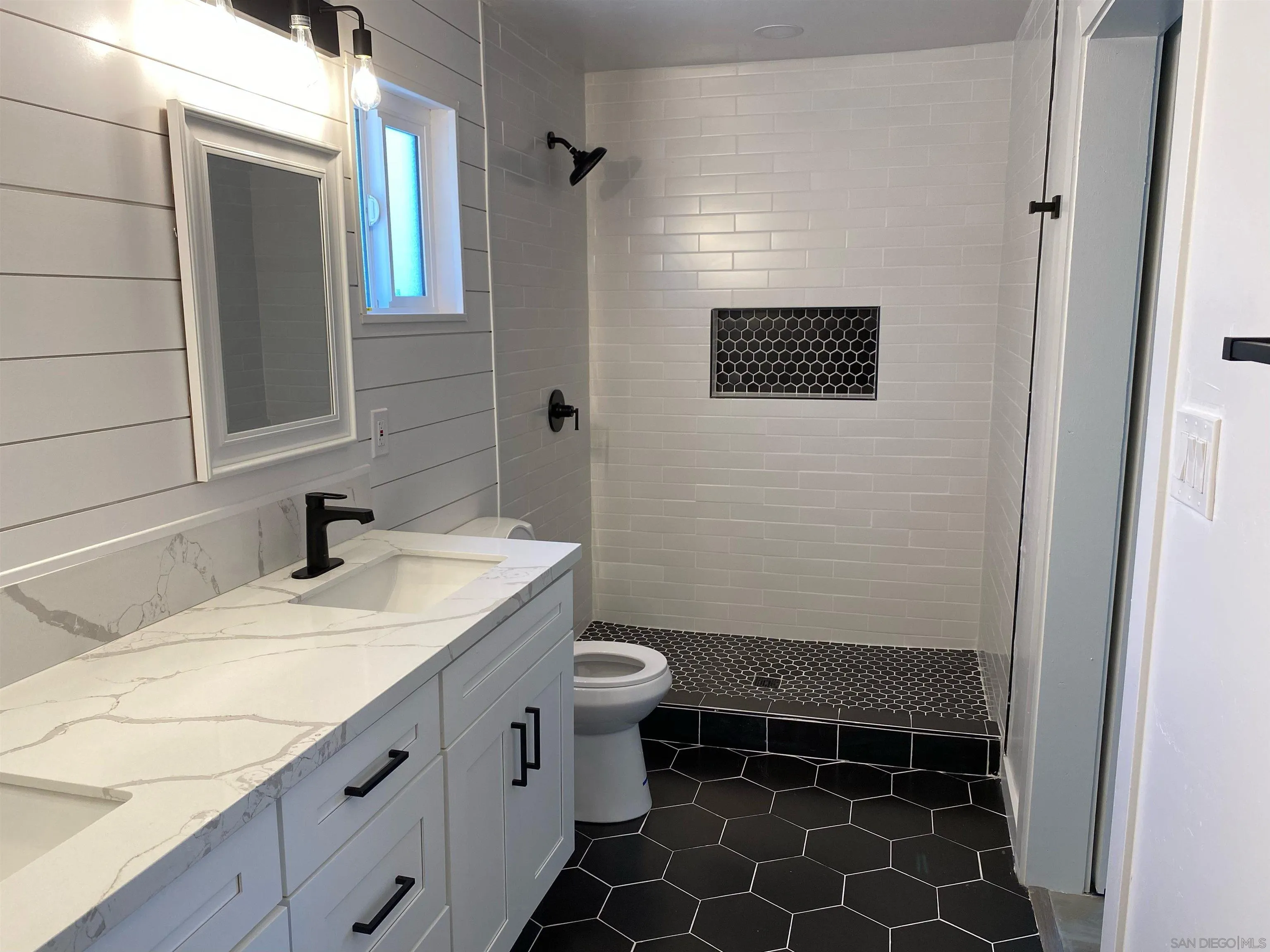 3866 Spring Drive Spring Valley, CA 91977 - Photo 5 of 9 a bathroom with a sink a toilet and a mirror