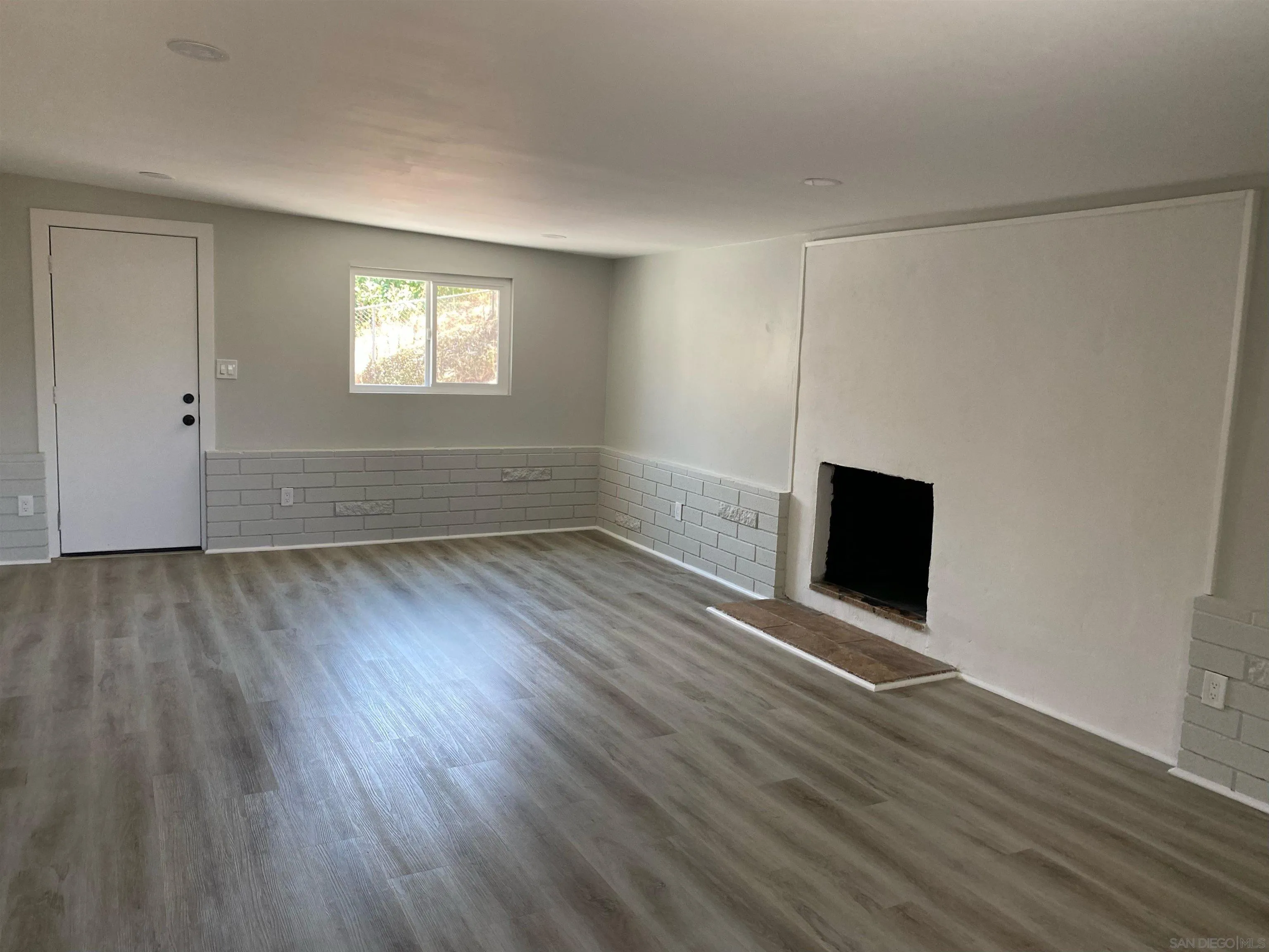 3866 Spring Drive Spring Valley, CA 91977 - Photo 7 of 9 a view of an empty room with wooden floor and a window