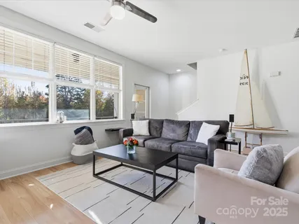 a living room with furniture and a floor to ceiling window