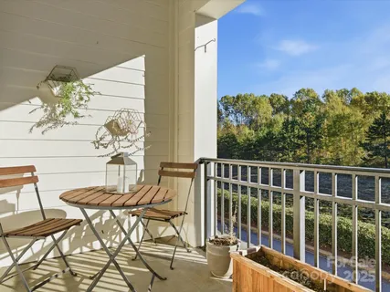 a view of a balcony with chair and table