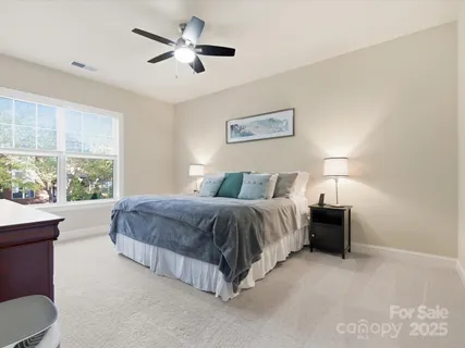 a spacious bedroom with a bed and a large window