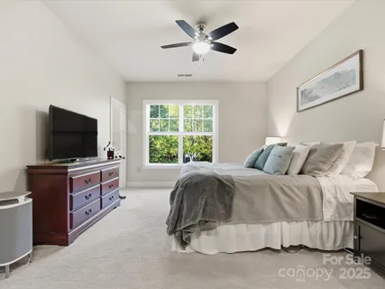 a living room with a bed and a flat screen tv