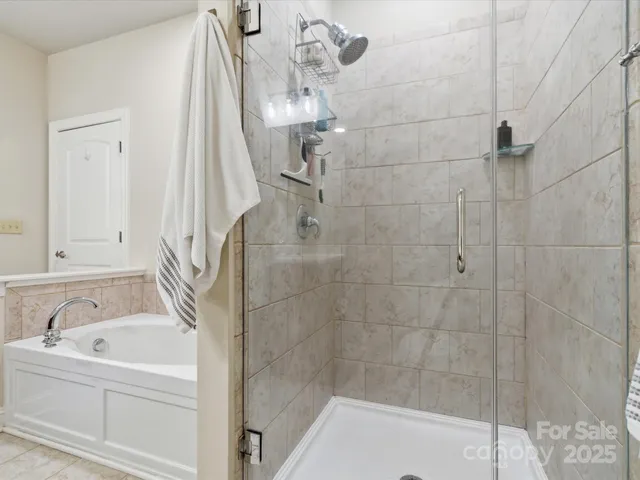 a bathroom with a bathtub and shower