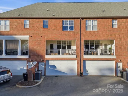 a front view of a house with a parking space