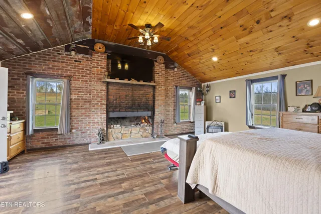 a bedroom with a bed window and a flat screen tv