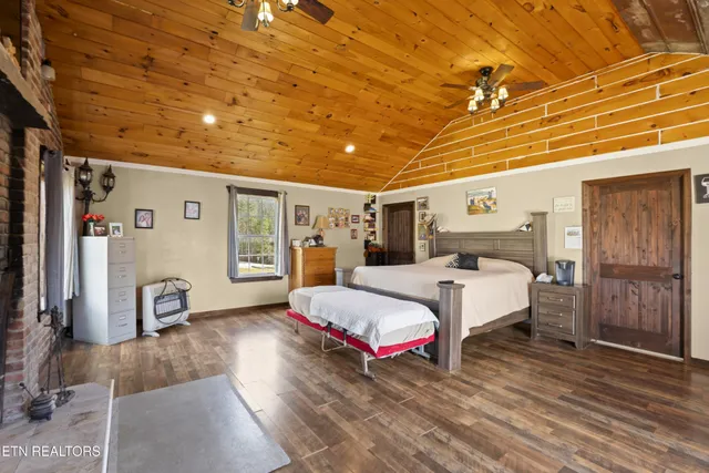 a spacious bedroom with a bed next to a window