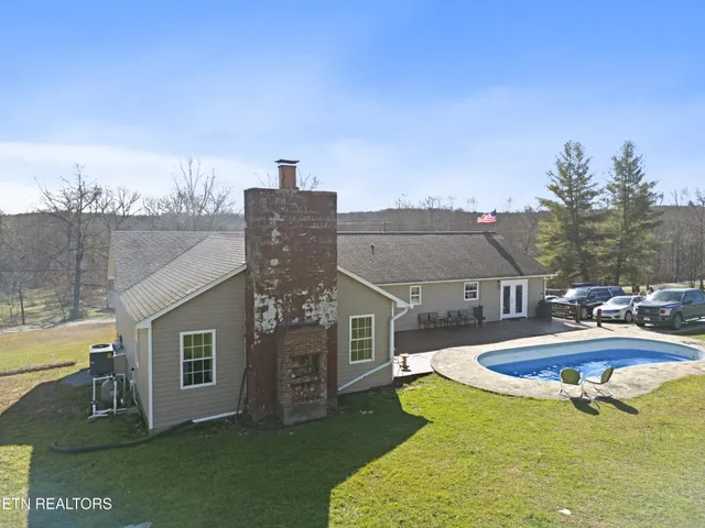 a view of a house with swimming pool and porch
