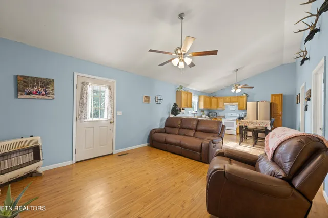 a living room with furniture ceiling fan and a rug
