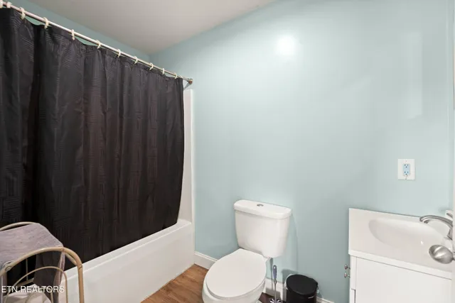 a white toilet sitting next to a bathroom sink