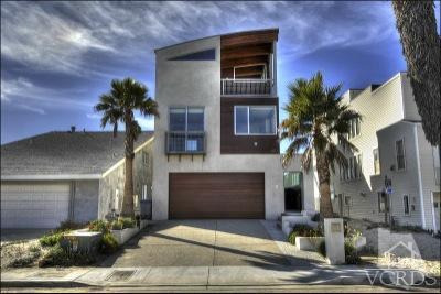 1013 Mandalay Beach Road Oxnard, CA 93035 - Photo 3 of 30 a front view of a house with a yard and garage