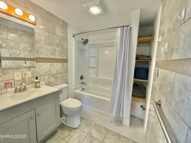 a view of a backyard with plants and large tree