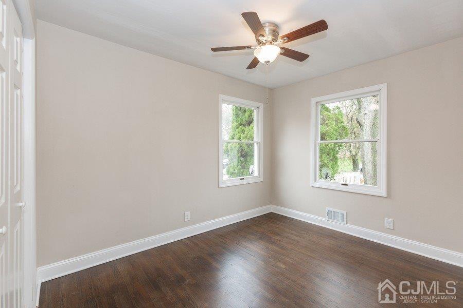 20 Brandeis Road Old Bridge, NJ 08859 - Photo 11 of 18 an empty room with wooden floor and windows