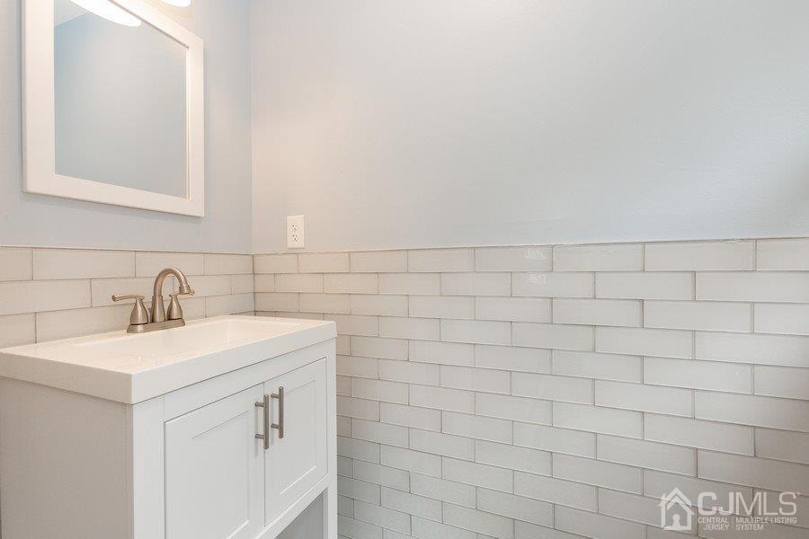 20 Brandeis Road Old Bridge, NJ 08859 - Photo 13 of 18 a bathroom with a sink a vanity and a mirror
