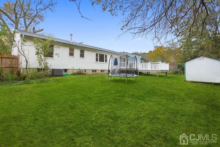 20 Brandeis Road Old Bridge, NJ 08859 - Photo 17 of 18 a view of a house with a yard and sitting area