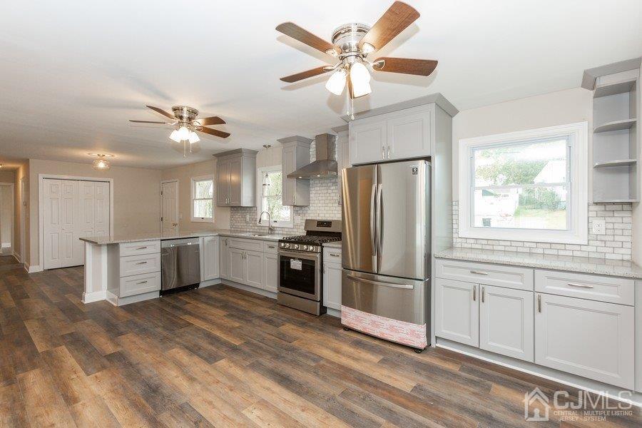 20 Brandeis Road Old Bridge, NJ 08859 - Photo 4 of 18 a kitchen with a refrigerator a sink and cabinets