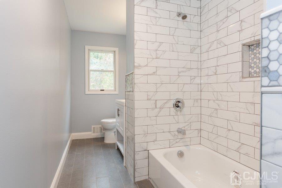 20 Brandeis Road Old Bridge, NJ 08859 - Photo 8 of 18 a bathroom with a bathtub and toilet