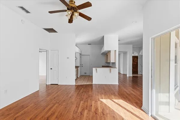 a view of a kitchen and wooden floor