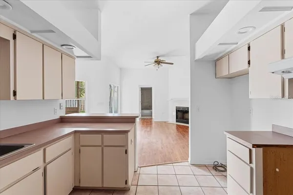 a kitchen with white cabinets and sink