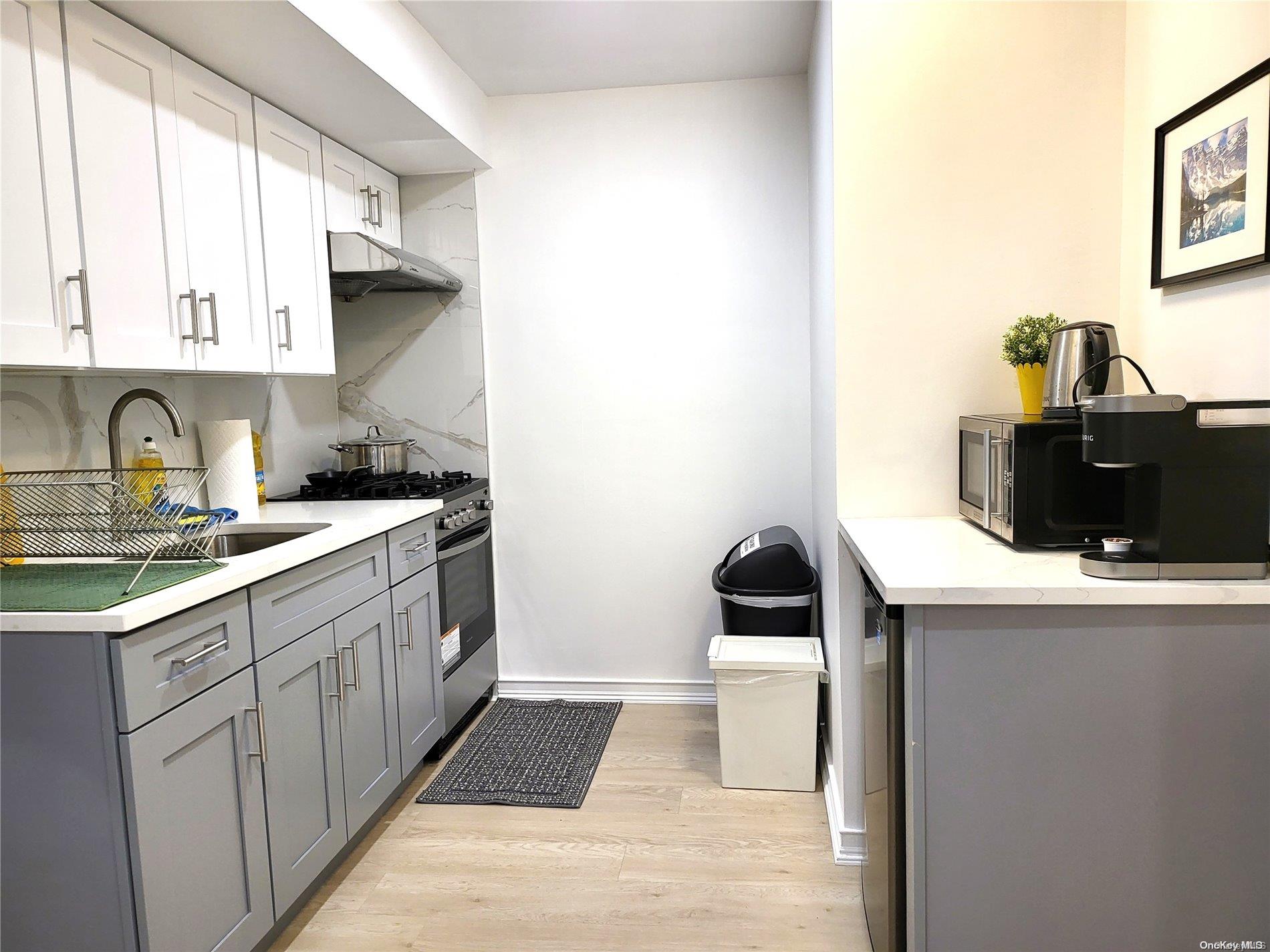 85-19 75th Street Queens, NY 11421 - Photo 6 of 17 a kitchen with a sink and cabinets
