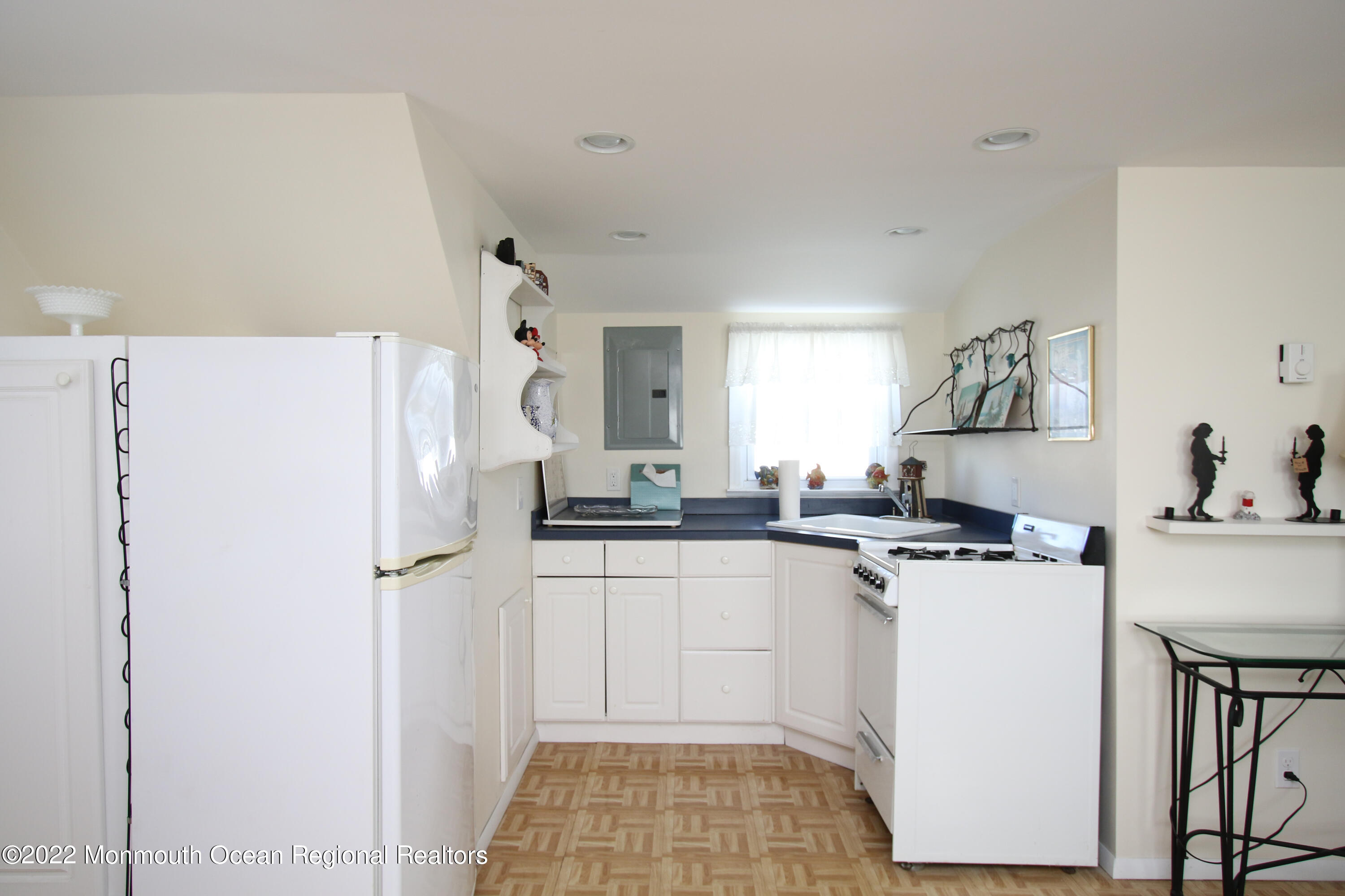 1401 Long Beach Boulevard Beach Haven, NJ 08008 - Photo 14 of 17 a kitchen with a sink a refrigerator and cabinets