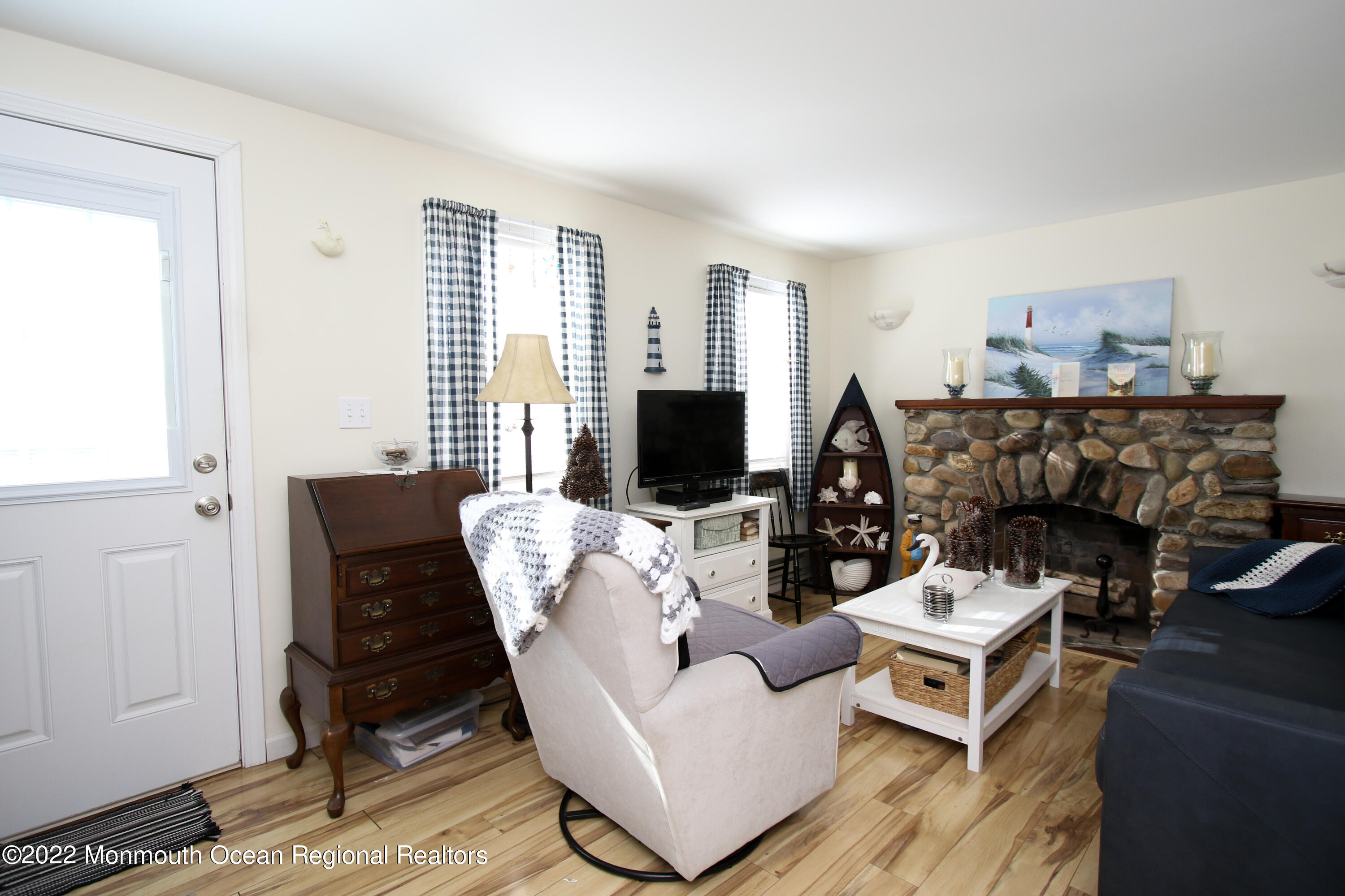 1401 Long Beach Boulevard Beach Haven, NJ 08008 - Photo 3 of 17 a living room with furniture a flat screen tv and a fireplace
