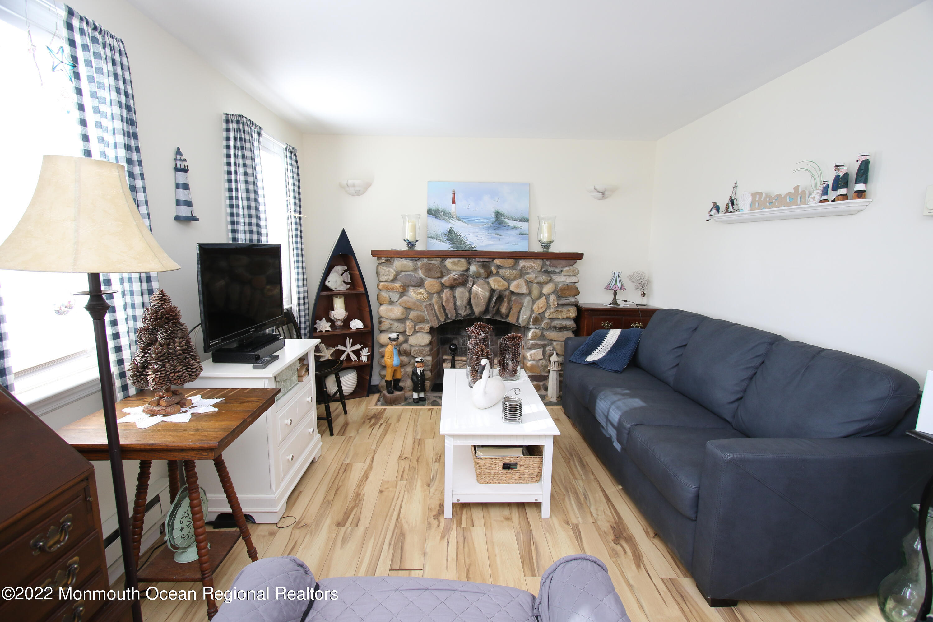 1401 Long Beach Boulevard Beach Haven, NJ 08008 - Photo 4 of 17 a living room with furniture a flat screen tv and a fireplace