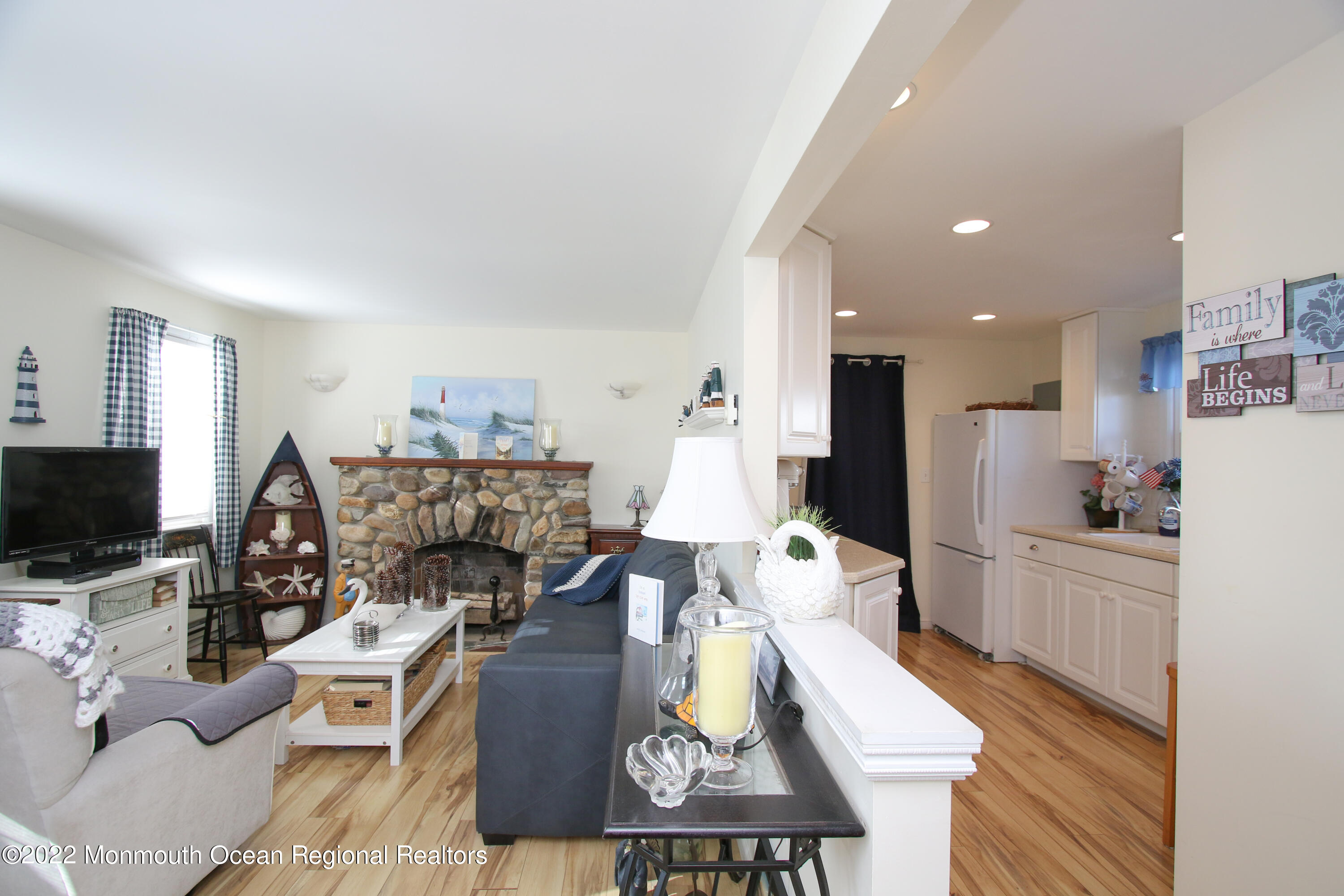 1401 Long Beach Boulevard Beach Haven, NJ 08008 - Photo 6 of 17 a living room with furniture a flat screen tv and a fireplace