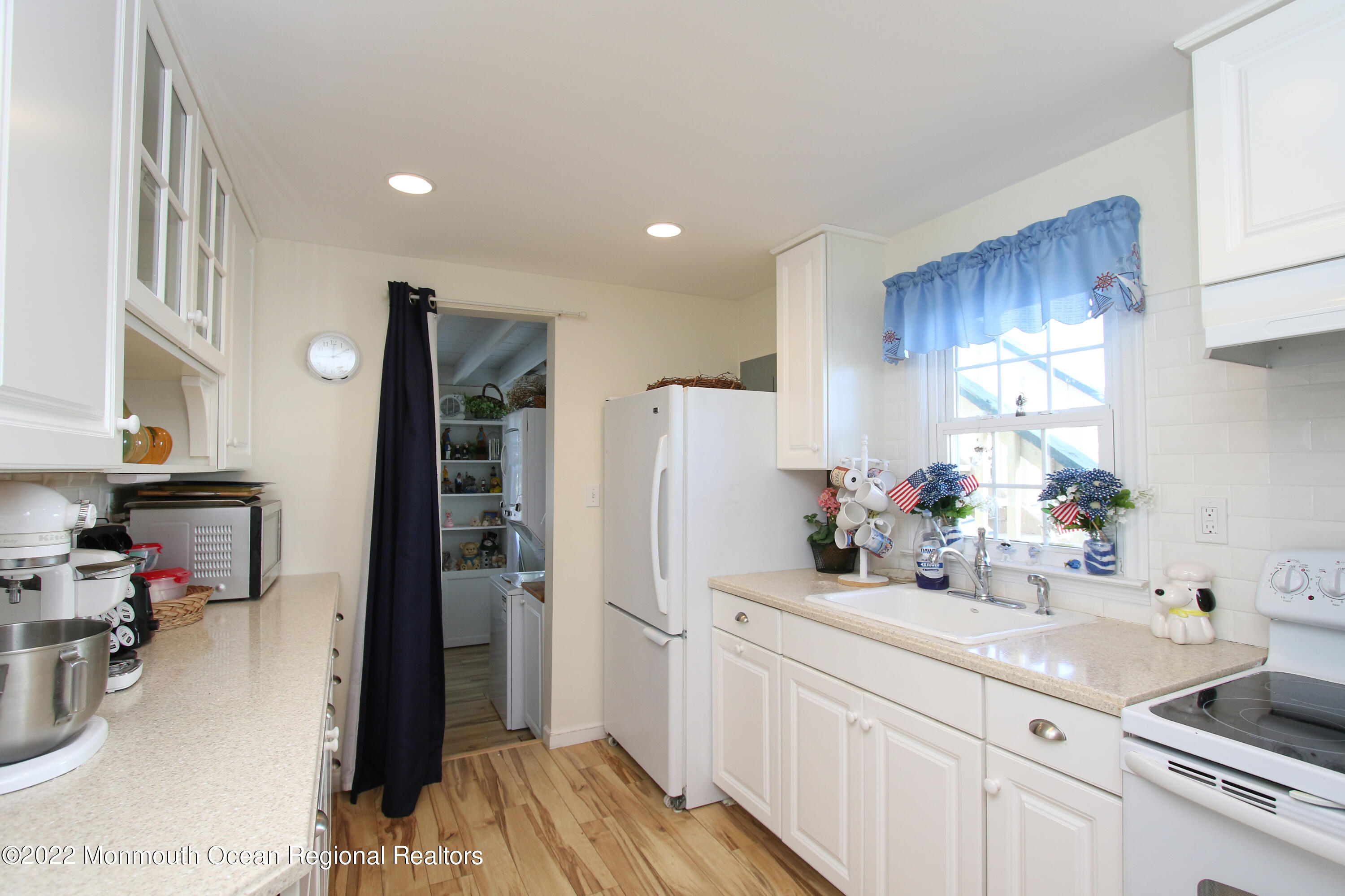 1401 Long Beach Boulevard Beach Haven, NJ 08008 - Photo 7 of 17 a kitchen with a sink dishwasher stove and refrigerator with wooden floor