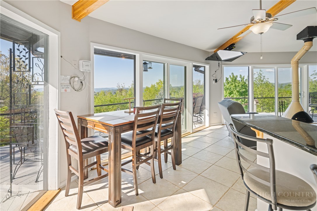 146 Cherokee Lane Purlear, NC 28665 - Photo 11 of 49 a view of a dining room with furniture large windows and wooden floor
