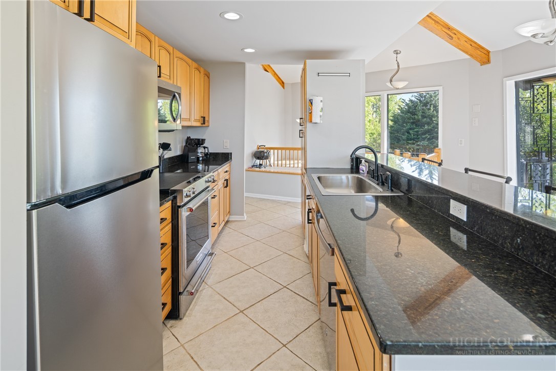 146 Cherokee Lane Purlear, NC 28665 - Photo 13 of 49 a kitchen with granite countertop a sink a counter top space and stainless steel appliances