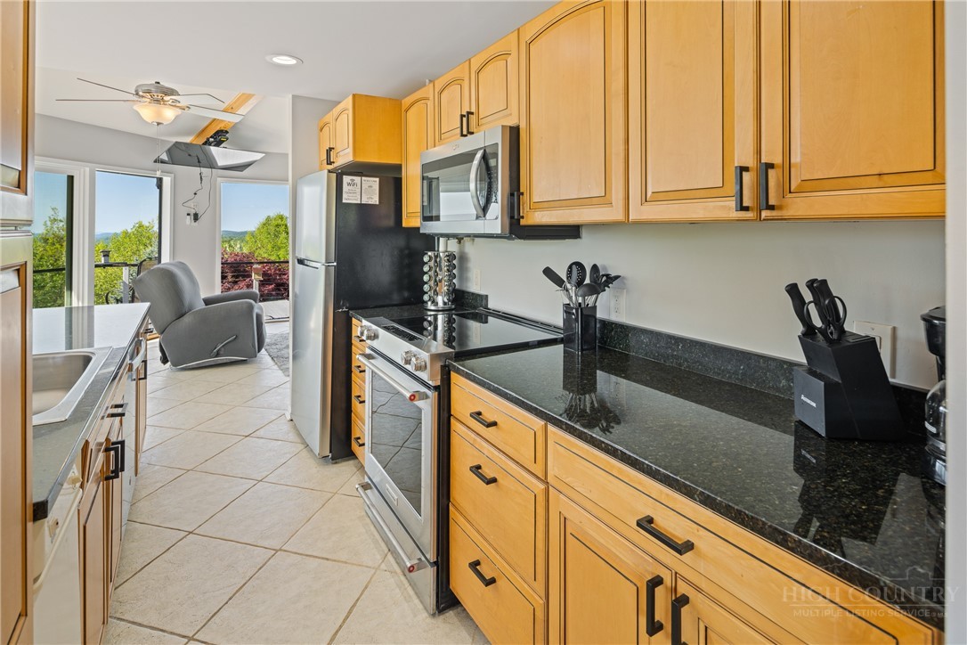 146 Cherokee Lane Purlear, NC 28665 - Photo 14 of 49 a kitchen with stainless steel appliances granite countertop a sink and cabinets