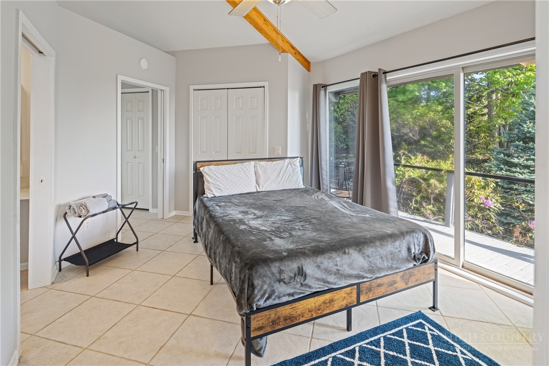 146 Cherokee Lane Purlear, NC 28665 - Photo 19 of 49 a bed sitting in a bedroom next to a window
