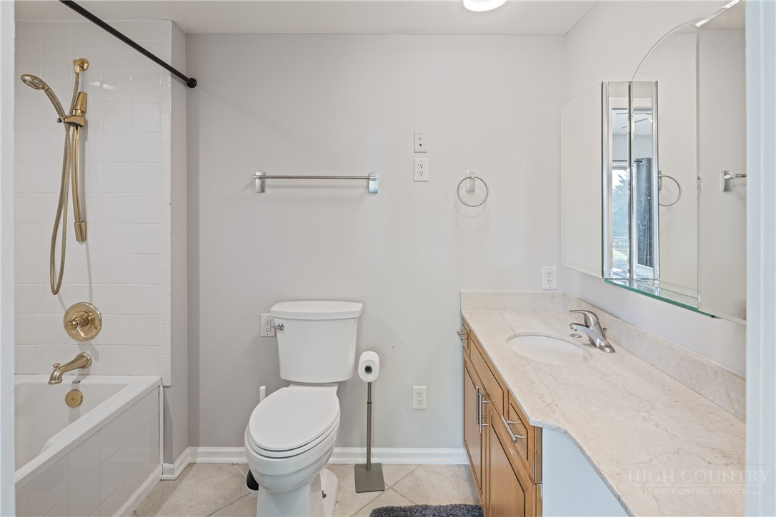 146 Cherokee Lane Purlear, NC 28665 - Photo 21 of 49 a bathroom with a granite countertop sink toilet and shower