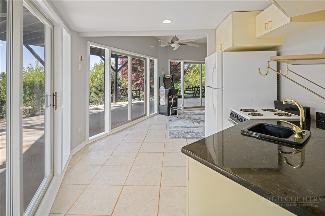 146 Cherokee Lane Purlear, NC 28665 - Photo 24 of 49 a room with patio furniture and a floor to ceiling window
