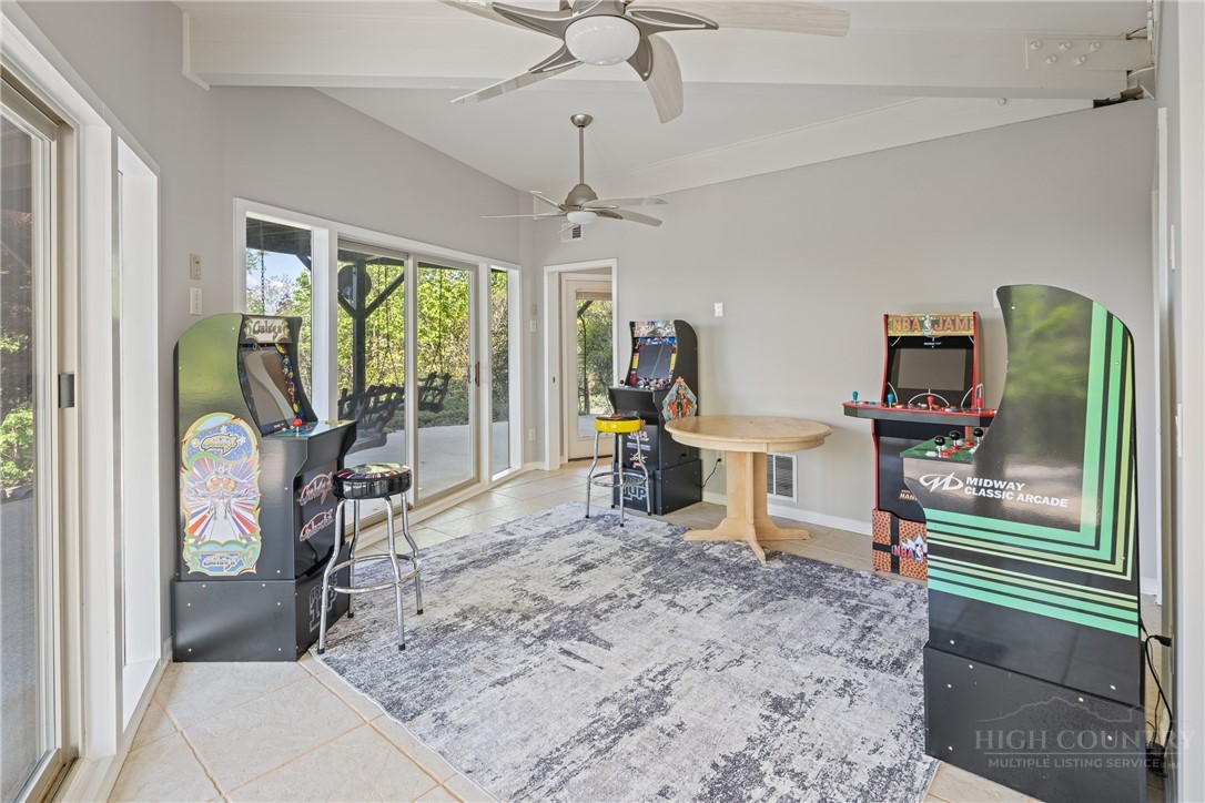 146 Cherokee Lane Purlear, NC 28665 - Photo 25 of 49 a living room with furniture a flat screen tv and a floor to ceiling window