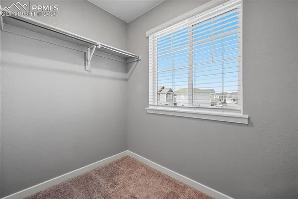 an empty room with windows and closet