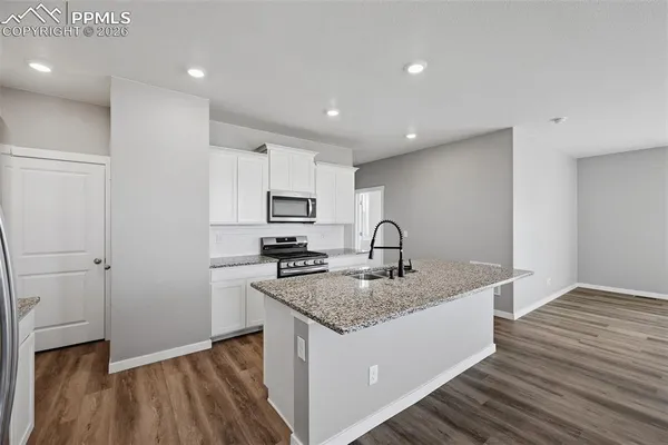 a kitchen with a sink stove and refrigerator