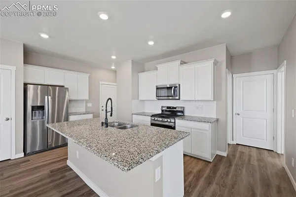 a view of kitchen with stainless steel appliances granite countertop refrigerator stove a sink and dishwasher