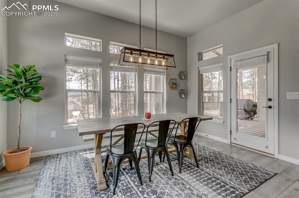 16430 Dancing Bear Lane Monument, CO 80132 - Photo 15 of 50 a view of a dining room with furniture window and wooden floor
