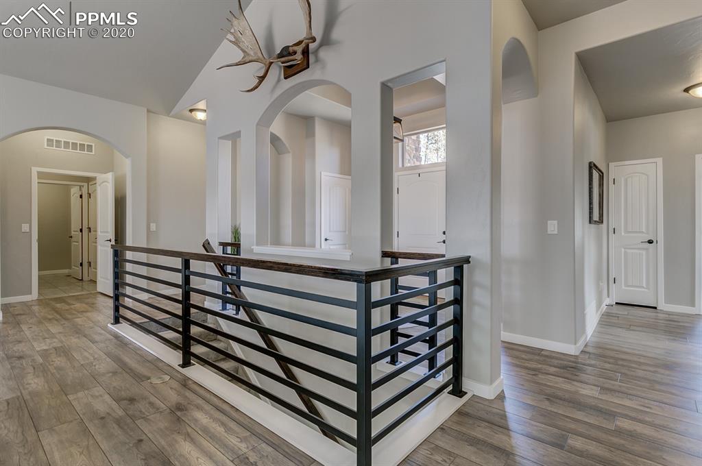 16430 Dancing Bear Lane Monument, CO 80132 - Photo 16 of 50 a view of a hallway with wooden floor and staircase