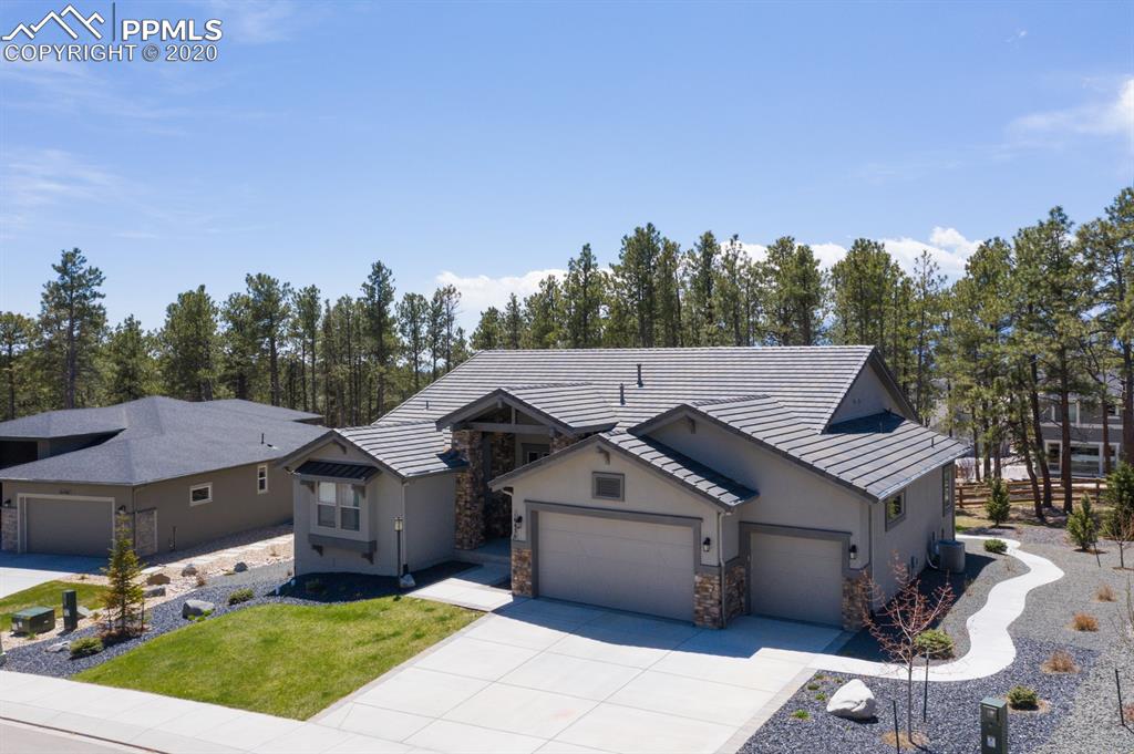 16430 Dancing Bear Lane Monument, CO 80132 - Photo 2 of 50 a aerial view of a house with a yard and sitting area